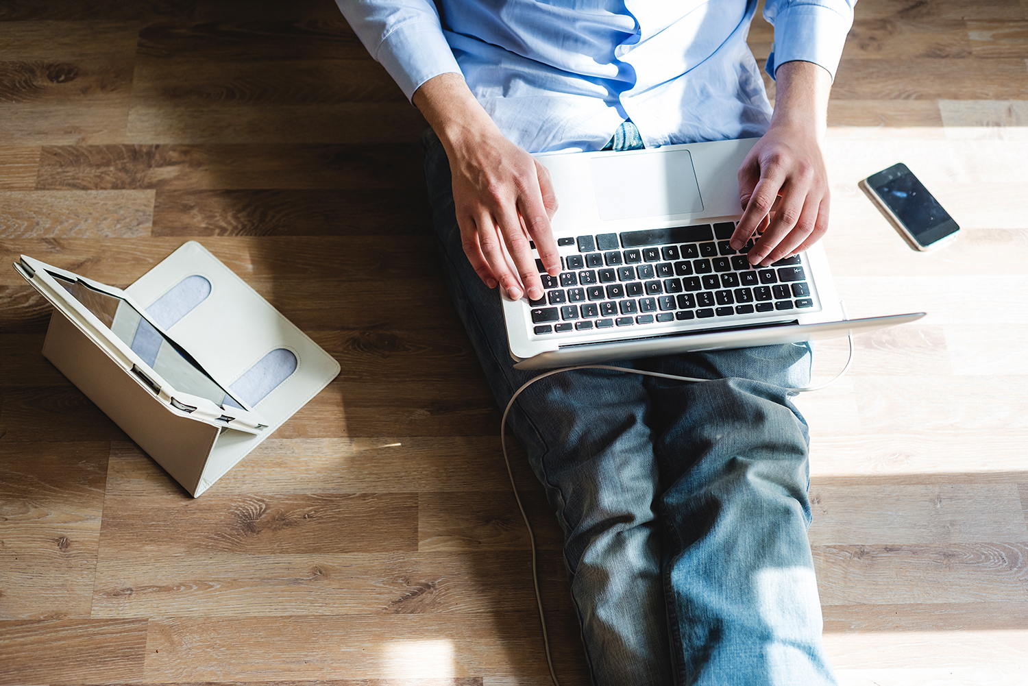 Person looking at their online home inspection report on a laptop, tablet, and smartphone