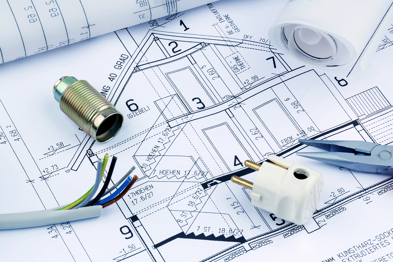 Blueprint of house with electrical tools used by our home inspectors 