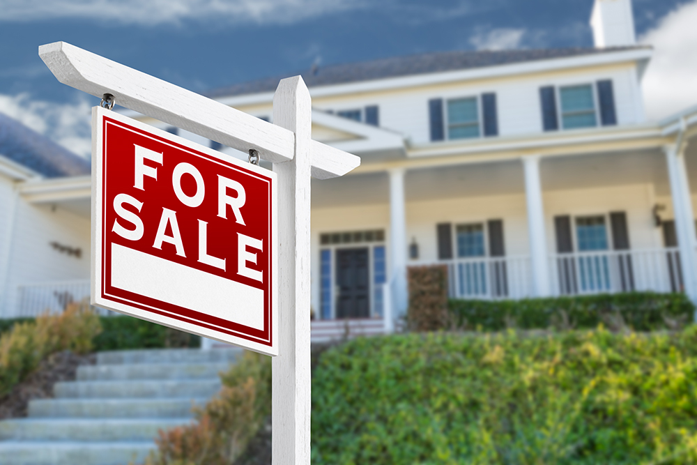 For sale sign in front of a house before home inspected services are preformed